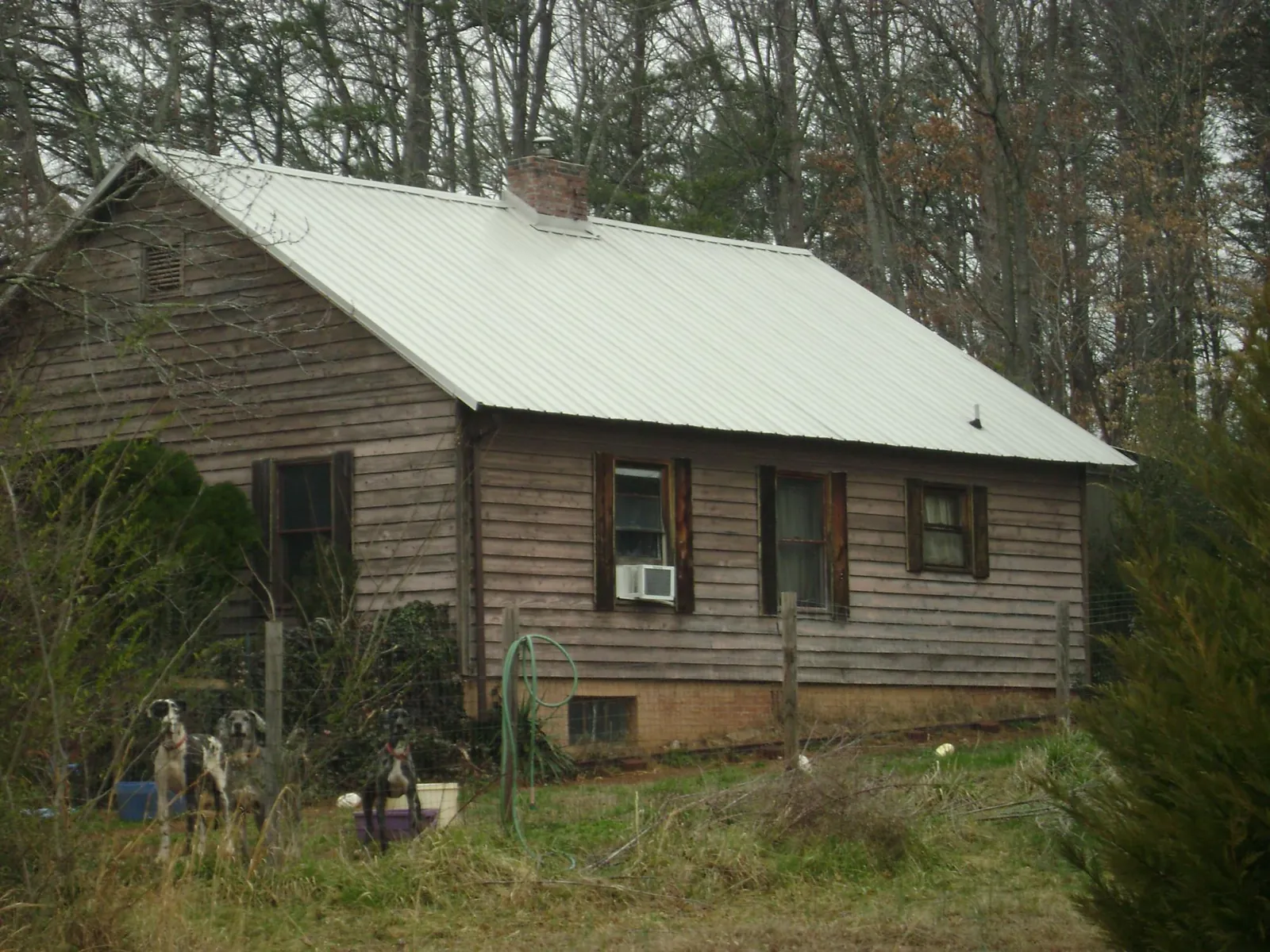 White metal roof on an old wood sided farmhouse, from a Metal Roof Installation job in Russell Springs